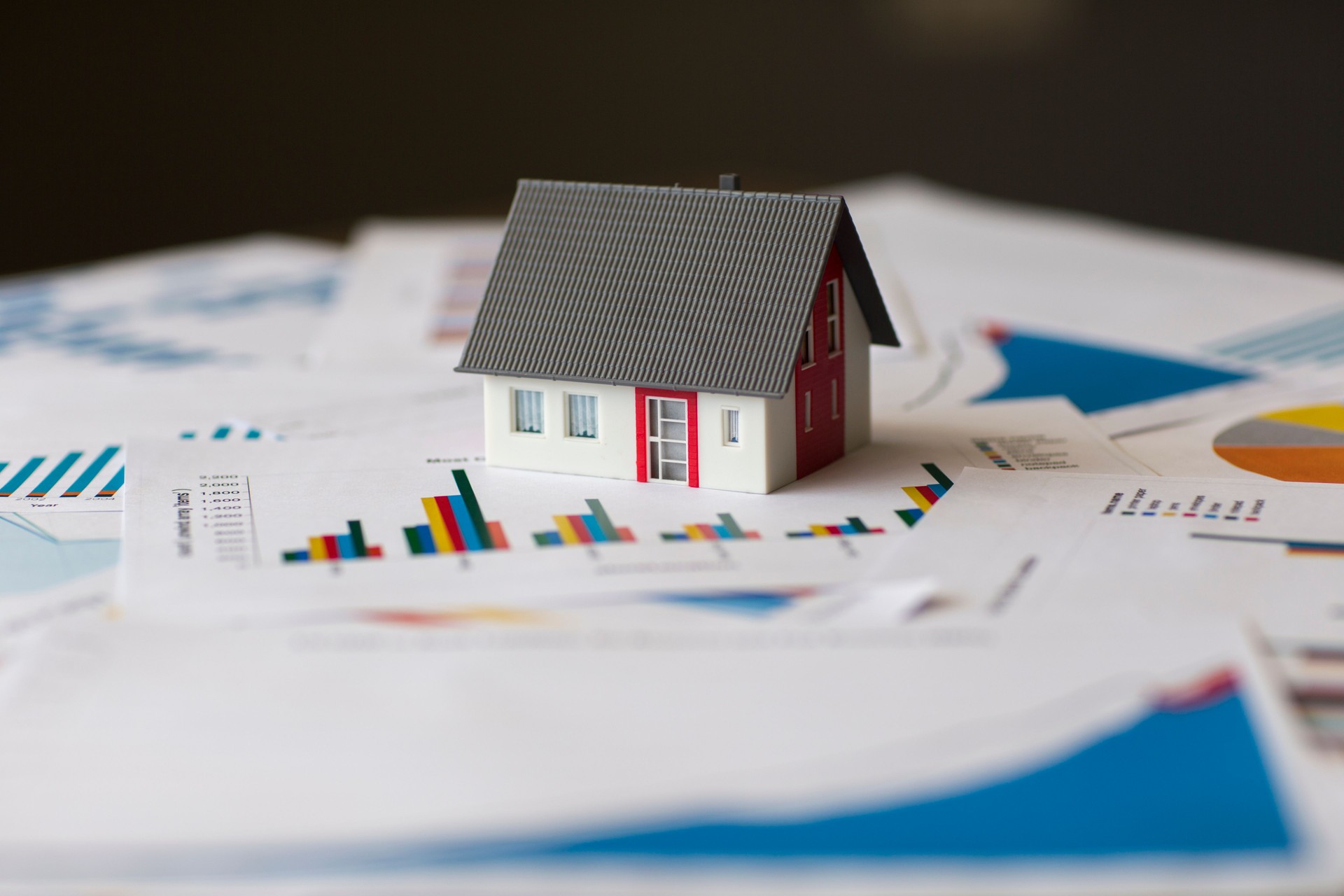 Miniature House on A Financial Graph